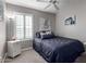 Well-lit bedroom with a full-size bed and ceiling fan at 15415 S 37Th Pl, Phoenix, AZ 85044