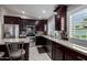 Kitchen features dark wood cabinets, granite countertops, and stainless steel appliances at 15415 S 37Th Pl, Phoenix, AZ 85044