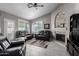 Living room with a stone fireplace, comfortable seating, and large windows at 15415 S 37Th Pl, Phoenix, AZ 85044