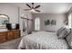 Main bedroom with king bed, ceiling fan, and access to en-suite bathroom at 15415 S 37Th Pl, Phoenix, AZ 85044