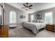 Spacious main bedroom with king-size bed, ceiling fan, and barn door at 15415 S 37Th Pl, Phoenix, AZ 85044