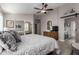 Main bedroom with king bed, ceiling fan, and access to en-suite bathroom at 15415 S 37Th Pl, Phoenix, AZ 85044