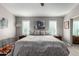 Main bedroom with a king bed and ceiling fan, plus a view into the bathroom at 15415 S 37Th Pl, Phoenix, AZ 85044