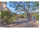 Landscaped front yard with gravel, desert plants, and mature trees at 15859 N Nyack Dr, Fountain Hills, AZ 85268