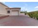 Attached garage with a white door and brick driveway at 15859 N Nyack Dr, Fountain Hills, AZ 85268