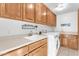 Laundry room with wood cabinets, washer, and dryer at 15859 N Nyack Dr, Fountain Hills, AZ 85268