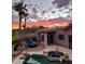 Stunning sunset view over a private backyard pool and spa with lounge chairs at 15959 E Brodiea Dr, Fountain Hills, AZ 85268