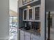 Granite-topped wet bar with glass-front cabinets at 15959 E Brodiea Dr, Fountain Hills, AZ 85268