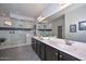 Modern bathroom boasts double sinks, large walk-in shower, and dark brown vanity at 16871 W Cielo Grande Ave, Surprise, AZ 85387