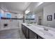 Spacious bathroom with double vanity, walk in shower, and gray floor tile at 16871 W Cielo Grande Ave, Surprise, AZ 85387