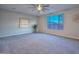 Spacious bedroom with window, ceiling fan and large clock at 16871 W Cielo Grande Ave, Surprise, AZ 85387