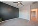 Spacious bedroom featuring carpet, ceiling fan and double doors to closet at 16871 W Cielo Grande Ave, Surprise, AZ 85387