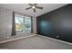 Bright bedroom with carpet flooring, ceiling fan, and large windows at 16871 W Cielo Grande Ave, Surprise, AZ 85387