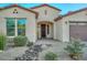 Home with a 3-car garage, rock landscaping, and walkway at 16871 W Cielo Grande Ave, Surprise, AZ 85387