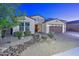 Two-story home with a three-car garage and nicely landscaped front yard at 16871 W Cielo Grande Ave, Surprise, AZ 85387