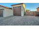 Extended garage with extra storage space and a wooden gate at 16871 W Cielo Grande Ave, Surprise, AZ 85387