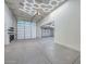 Large garage with hexagon light fixtures and polished concrete floor at 16871 W Cielo Grande Ave, Surprise, AZ 85387