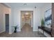 Long hallway with tile floors and modern wall art at 16871 W Cielo Grande Ave, Surprise, AZ 85387