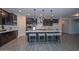 Modern kitchen with large island, dark cabinets, and white quartz countertops at 16871 W Cielo Grande Ave, Surprise, AZ 85387