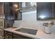 Modern kitchen detail: stainless steel range hood and white herringbone backsplash at 16871 W Cielo Grande Ave, Surprise, AZ 85387