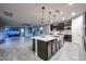 Open concept kitchen with island, stainless steel appliances, and dark cabinets at 16871 W Cielo Grande Ave, Surprise, AZ 85387