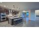 Modern kitchen with island, stainless steel appliances and dark cabinets at 16871 W Cielo Grande Ave, Surprise, AZ 85387