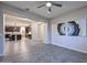 Open living room with kitchen view and ceiling fan at 16871 W Cielo Grande Ave, Surprise, AZ 85387