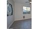 Living room with wood-look tile floors and large windows at 16871 W Cielo Grande Ave, Surprise, AZ 85387