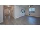 Living room with wood-look tile and access to entryway at 16871 W Cielo Grande Ave, Surprise, AZ 85387