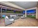 Evening view of covered patio with fire pit and seating at 16871 W Cielo Grande Ave, Surprise, AZ 85387