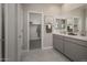 Bathroom with double vanity, gray cabinets and walk-in shower at 17058 W Seldon Ln, Waddell, AZ 85355