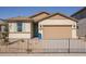 Single-story home with a two-car garage and a landscaped front yard at 17058 W Seldon Ln, Waddell, AZ 85355