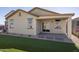 Back exterior view showing a covered patio and landscaping at 17058 W Seldon Ln, Waddell, AZ 85355