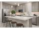 Modern kitchen with gray cabinets, white countertops and island with seating at 17058 W Seldon Ln, Waddell, AZ 85355