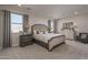 Spacious main bedroom with gray carpet and large windows at 17058 W Seldon Ln, Waddell, AZ 85355