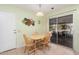 Bright kitchen with a light-colored table and chairs near sliding glass doors at 18014 N Broken Bow Ct, Sun City, AZ 85373