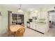 Bright kitchen features white cabinets, green countertops, and a dining area at 18014 N Broken Bow Ct, Sun City, AZ 85373