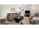 Living room with neutral colored couches, chairs, and a large window at 18014 N Broken Bow Ct, Sun City, AZ 85373