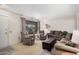 Living room with neutral colored couches, chairs, and a large window at 18014 N Broken Bow Ct, Sun City, AZ 85373