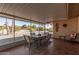 Screened patio with seating area and view of backyard at 18014 N Broken Bow Ct, Sun City, AZ 85373