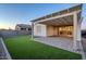 Artificial turf lawn, covered patio with pergola, and block wall at 18055 W Muirwood Dr, Goodyear, AZ 85338