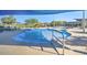 Community pool with a spa and shade structures at 18055 W Muirwood Dr, Goodyear, AZ 85338