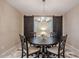 Dining area with barn doors and a round wooden table at 18055 W Muirwood Dr, Goodyear, AZ 85338