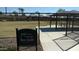 Dog park with fenced area, shaded seating, and a sign at 18055 W Muirwood Dr, Goodyear, AZ 85338