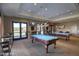 Community game room with two billiard tables and seating at 18055 W Muirwood Dr, Goodyear, AZ 85338