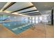 Indoor swimming pool with seating and wood beams at 18055 W Muirwood Dr, Goodyear, AZ 85338