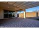 Covered patio with pergola, pavers, and access to the backyard at 18055 W Muirwood Dr, Goodyear, AZ 85338