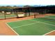 Several pickleball courts with benches and fencing at 18055 W Muirwood Dr, Goodyear, AZ 85338