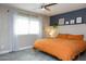 Bright bedroom, featuring an orange duvet and ceiling fan at 1860 S 24Th St, Mesa, AZ 85204