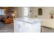 White kitchen island with granite countertop, offering extra prep space at 1860 S 24Th St, Mesa, AZ 85204